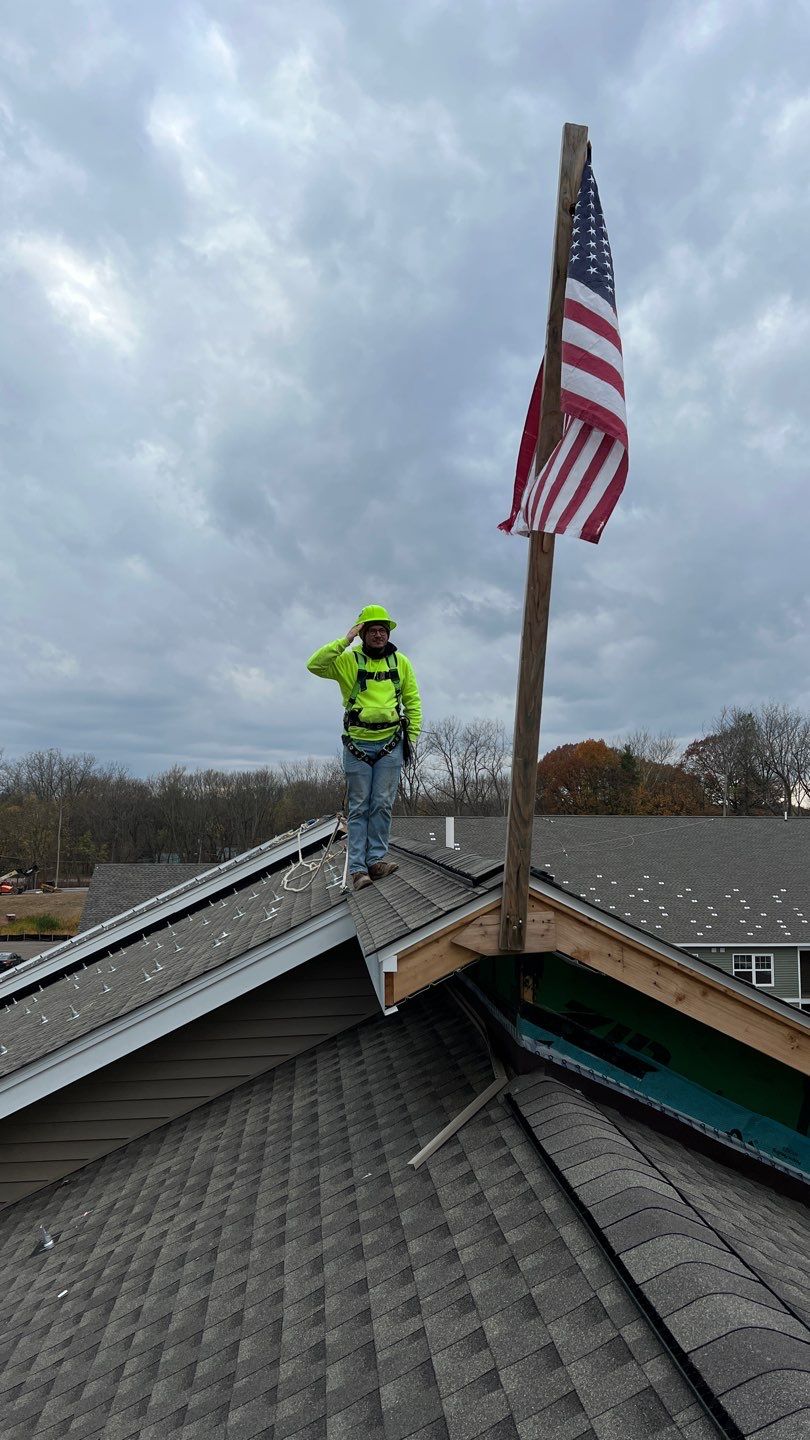 Two solar installers mounting the rails for a rooftop solar mount